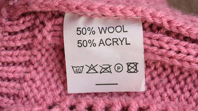 The care tag on a pink sweater