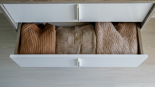 Warm sweaters in a dresser drawer