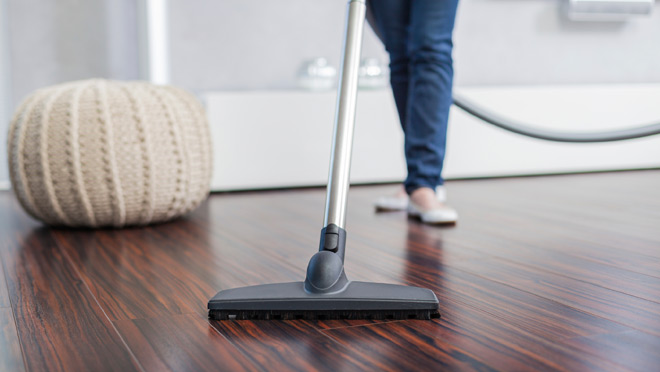 Image of woman vacuuming hardwood floor Image of woman vacuuming hardwood floor