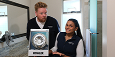 Dave and Jaclyn holding a water-saving showerhead