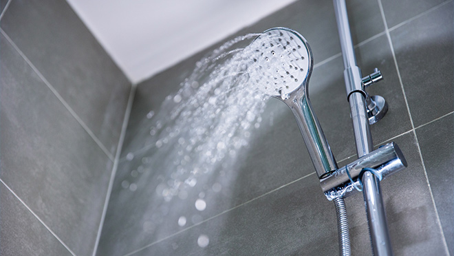 Water flowing from a showerhead Water flowing from a showerhead