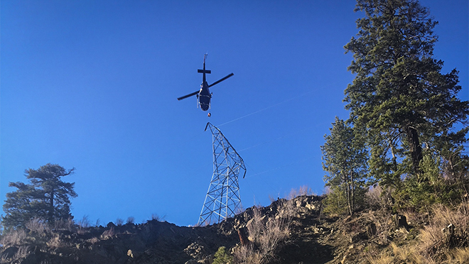 Image of a helicopter installing a transmission tower Image of a pole crew installing a new pole
