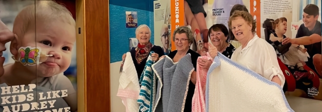 Power Pioneers showcasing their handmade creations as part of the Caring Crafts program, where members generously donate their time to knit, crochet or sew items for hospitals and other charities throughout B.C.
