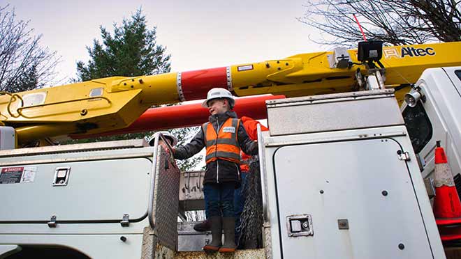 Finley standing on a BC Hydro bucket truck