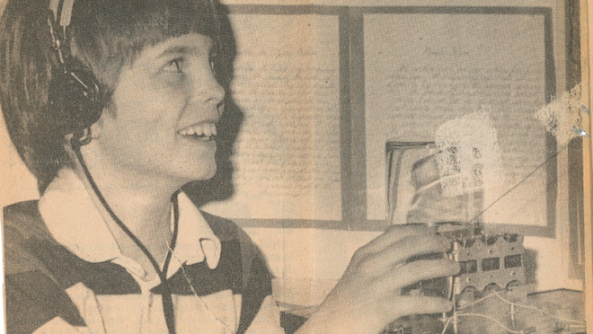 A newspaper clipping of future President and CEO Chris O'Riley with the crystal radio he built as a Grade 6 student