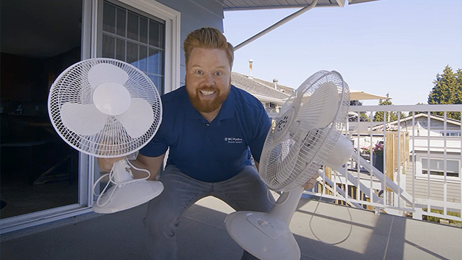 Image of Dave holding two electric fans