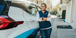 Jaclyn leaning on a car