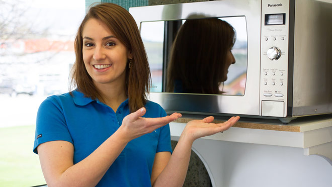 Image of BC Hydro's Kelsey McMorran with a microwave oven Image of BC Hydro's Kelsey McMorran with a microwave oven
