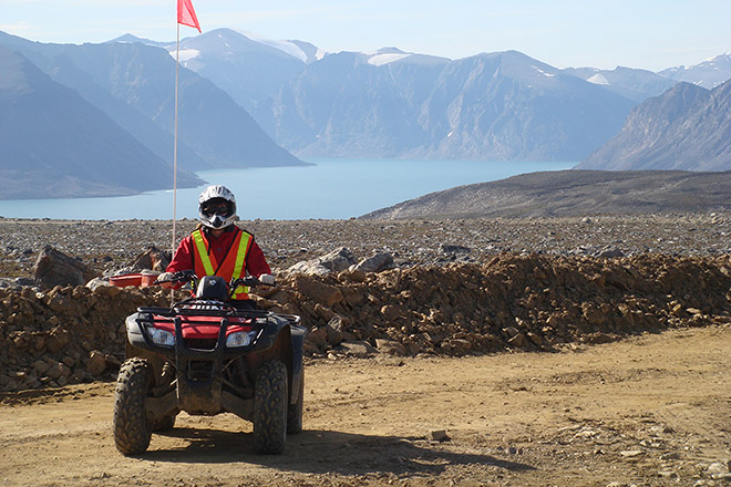 BC Hydro employee Molly Brewis rides an ATV on Baffin Island