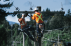 Helicopter lowering a BC Hydro line crew