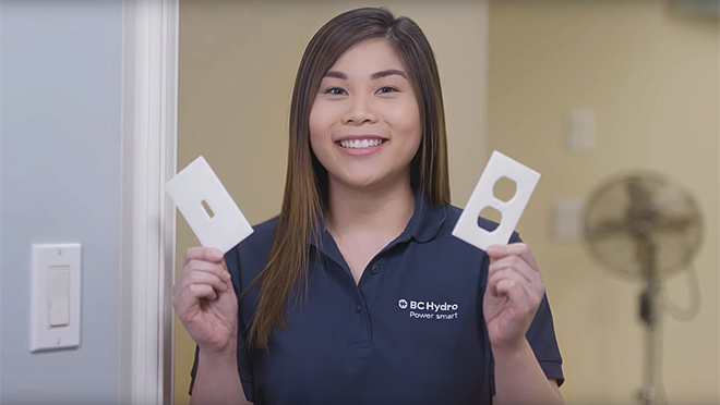 Image of Samantha Chan holding outlet and switch pads Image of Samantha Chan holding outlet and switch pads