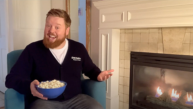 Image of Dave eating popcorn by a roaring fire