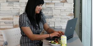 Woman working on her laptop during lunch