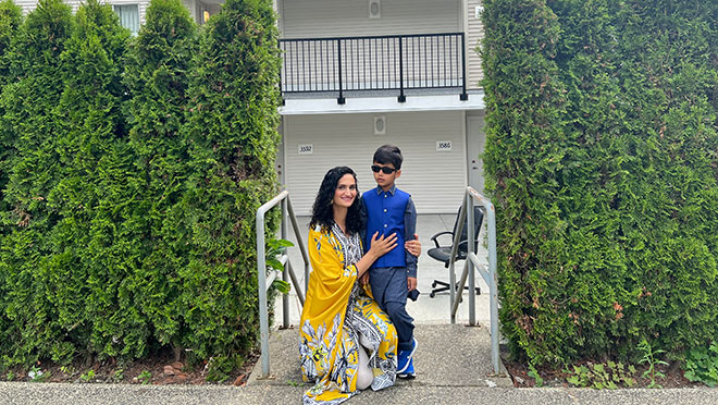 Aqdus Shaheen and son Muhammad Rayyan in front of their South Vancouver townhome