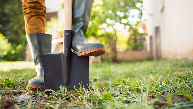 Person digging with a shovel Person digging with a shovel