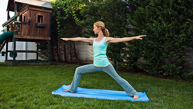 Image of a woman doing yoga in a backyard