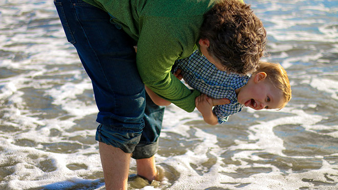 Image of father and son playing at the beach Image of father and son playing at the beach