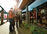 Three people standing outside a business at Granville Island Three people standing outside a business at Granville Island