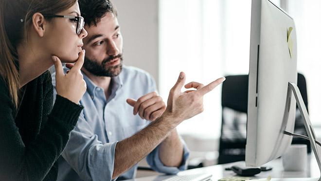 Image of business people following a webinar on a desktop computer Image of business people following a webinar on a desktop computer