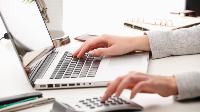 Image of businesswoman working with a laptop computer Image of businesswoman working with a laptop computer