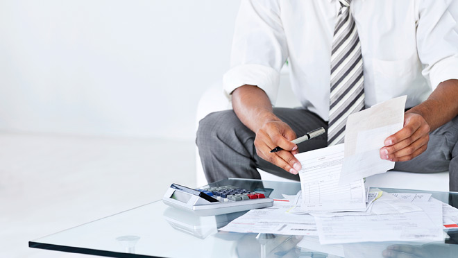 Image of businessman calculating invoices Image of businessman calculating invoices