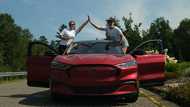 A Mustang Mach-E and drivers on the Charge North Tour