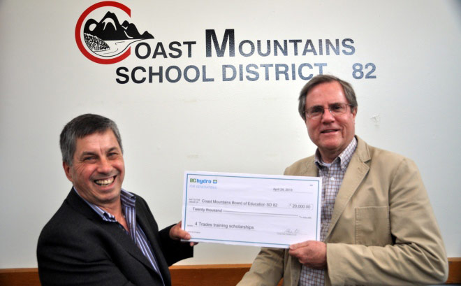 Bruce Barrett, vice-president of Transmission & Distribution Program Delivery, presents a cheque to Roger Leclerc, vice-chair of the Coast Mountains Board of Education. Bruce Barrett, vice-president of Transmission & Distribution Program Delivery, presents a cheque to Roger Leclerc, vice-chair of the Coast Mountains Board of Education.
