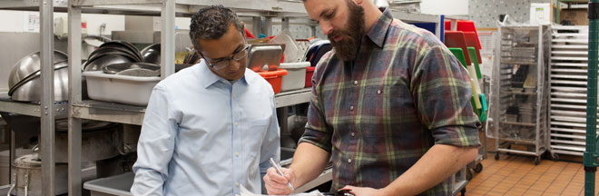 Men looking at a report. 