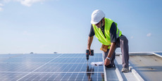 Contractor installing solar on business.