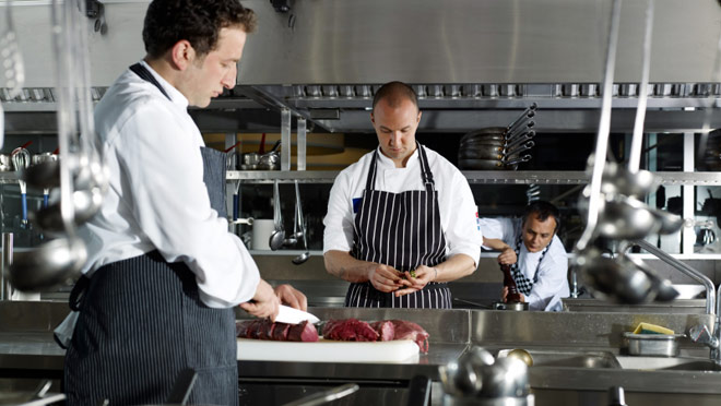 Image of cooks working in a restaurant kitchen Image of cooks working in a restaurant kitchen