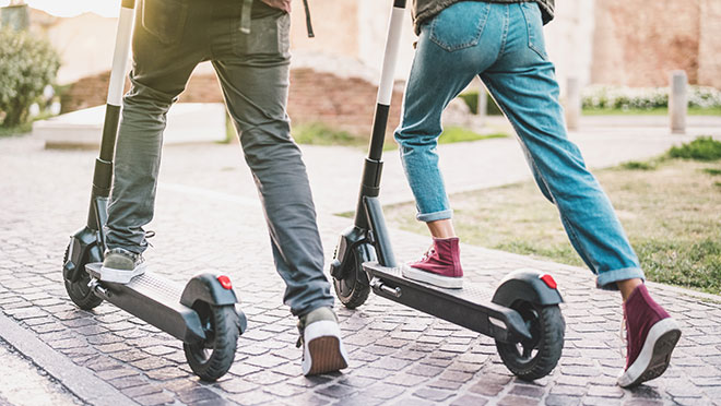 Image of couple riding electric scooters