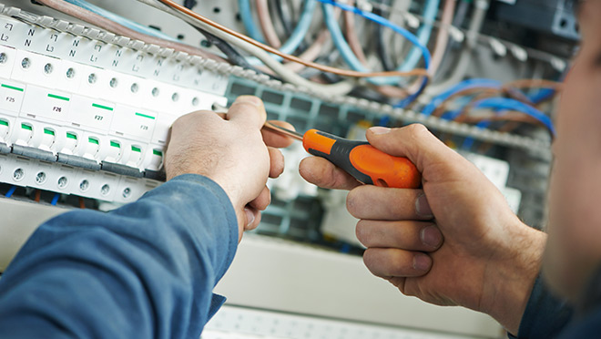 Image of an electrician at work