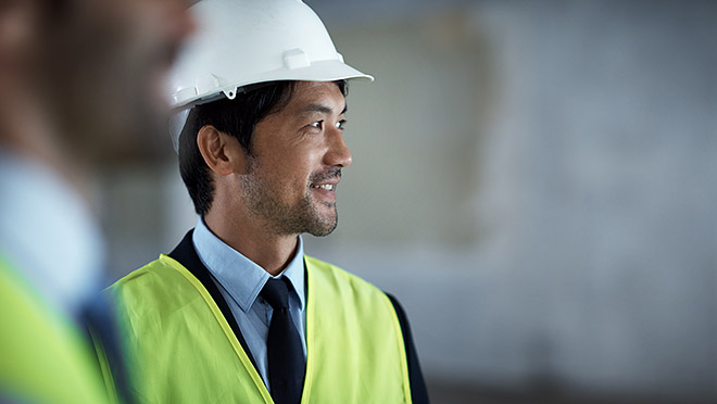 Image of an engineer wearing a high-visibility vest and hard hat