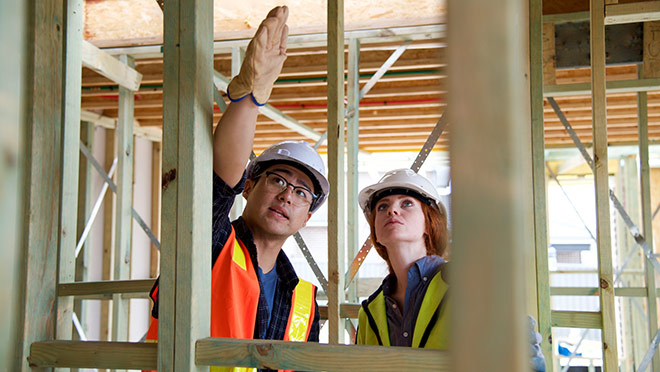 Tradespeople working in a home under construction