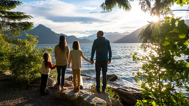 Image of a family standing next to a lake in British Columbia