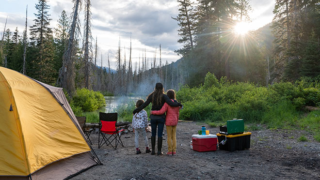 Image of a family watching the sun set while camping in British Columbia