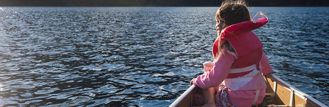 Image of girl with lifejacket in canoe Image of girl with lifejacket in canoe