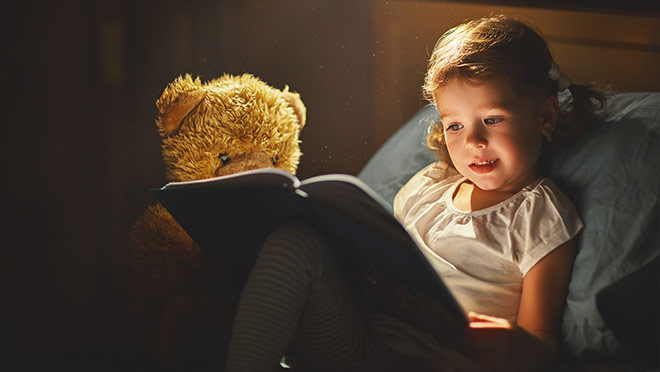 Image of young girl reading a book Image of young girl reading a book