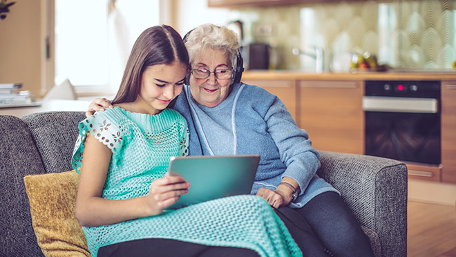 Image of a grandmother and granddaughter using a tablet computer