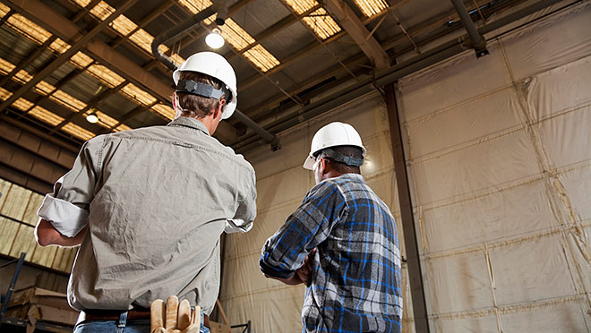 Two industrial workers in an industrial facility