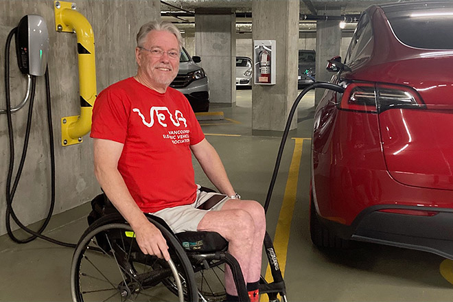 Jacques Courteau charges his wife's Tesla Model Y at the couple's Yaletown condo