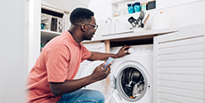 Man running washing machine at home