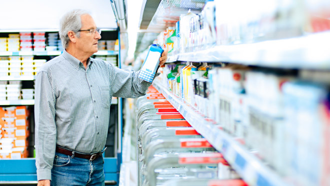 Image of man standing at a supermarket dairy cooler Image of man standing at a supermarket dairy cooler