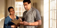 Man and woman looking at a clipboard