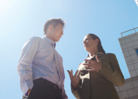 Two colleagues chatting outside Two colleagues chatting outside