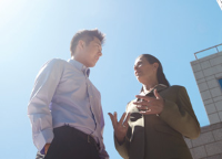 Two colleagues chatting outside