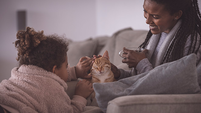 Image of a mother and daughter with their cat