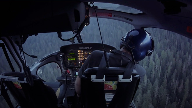 Image of a pilot leading a visual search from a North Shore Rescue helicopter