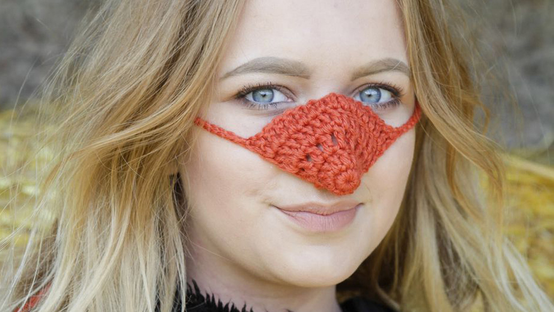 A woman wearing a knitted nose warmer A woman wearing a knitted nose warmer
