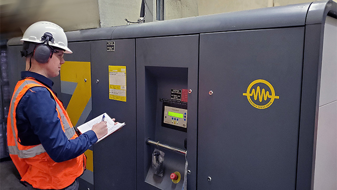 Photo of a worker looking at a couple valve meters Photo of a worker looking at a couple valve meters